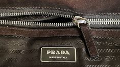 a prada made in italy bag with the label on it's side pocket