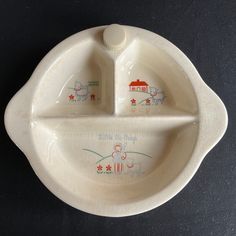 a white plate with two plates on it and a spoon in the shape of a boat