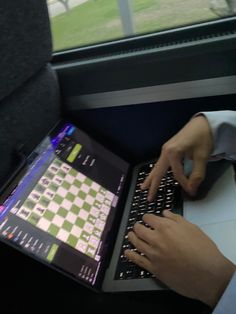 a person using a laptop computer on a train