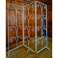 a room divider is shown with wooden paneling and wood flooring in the background