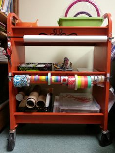 an orange cart with various crafting supplies on it