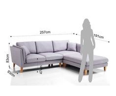 a person standing next to a sectional couch