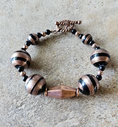 This bracelet is made with sterling silver wire, copper toggle clasp and assorted accent beads. Length of bracelet is 7in. Adjustable Beaded Bracelets With Toggle Clasp, Adjustable Beaded Copper Bracelets, Toggle Clasp, Silver Wire, Beaded Bracelet, Making Ideas, Jewelry Bracelets, Beaded Bracelets, Accessory Gift