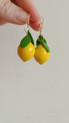 small yellow fruit earrings with green leaves on them