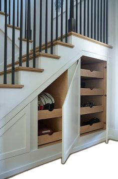 an under the stairs storage area for shoes