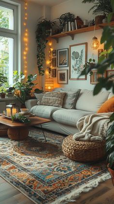 This photo shows a cozy living room decorated in a boho style with a touch of hygge. The room is full of plants, which creates a relaxing and inviting atmosphere. The warm colors and soft textures make this room feel like a perfect place to relax and unwind. The mix of patterns and prints adds a touch of personality and makes the room feel more eclectic. The overall effect is a stylish and inviting space that is perfect for relaxing or entertaining guests. Natural Boho Interior, House Decor Plants Bohemian, Rugs Mix And Match, Maximalist Decor Small Spaces Living Room, Navy And Terracotta Living Rooms, Natural Boho Living Room, Nature Home Aesthetic, Bohemian Modern Living Room, Aesthetic Plant Room