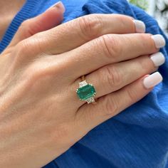 This Emerald & Diamond Cocktail Ring showcases a stunning 4.00-carat emerald-cut Zambian emerald, certified by GIA for its exceptional quality (F2 grade). Flanking the vibrant green emerald are two elegant trapezoid diamonds, totaling 0.70 carats (G color, VS clarity), adding brilliance and symmetry to the design. In a classic 18 karat yellow gold setting, this size 6.25 ring exudes timeless sophistication (can be sized), and measures 10 x 15mm on top. 22k Gold Ring, Art Deco Sapphire Ring, Oval Sapphire Ring, Sapphire Eternity Ring, Yellow Gold Cocktail Ring, Orange Ring, Art Nouveau Ring, Turquoise Gold Ring, Diamond Cocktail Ring