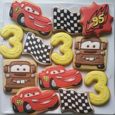 decorated cookies in the shape of cars and numbers