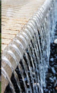 the water is running down the side of the fountain