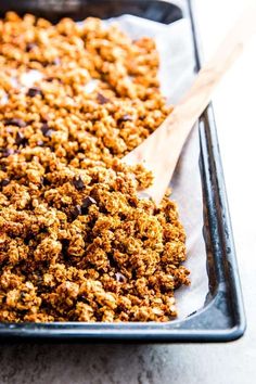 a baking pan filled with granola and chocolate chips