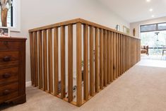 an empty living room with wood slats on the wall and carpeted flooring