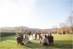 a group of people that are sitting in the grass