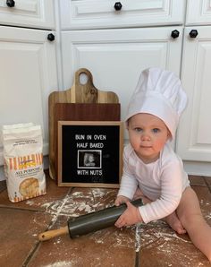 a baby is sitting on the floor with a chef's hat