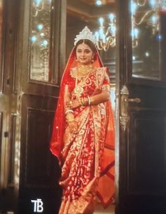 a woman in a red and gold bridal gown