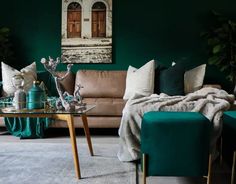 a living room with green walls and furniture