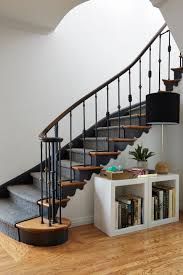 a staircase with bookshelves in the middle and an open bookcase below it