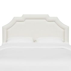 a bed with white linens and pillows on top of the headboard, in front of a white background