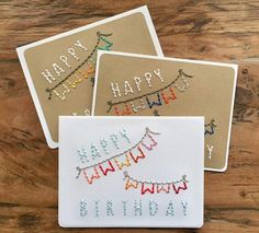 three cards with happy birthday written on them and string lights strung across the card's edges