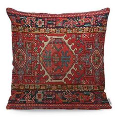 a red and blue pillow with an intricate design on the front, sitting on a white surface