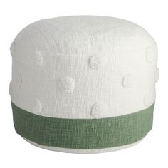 a white and green poufle sitting on top of a table