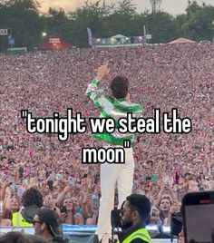 a man standing on top of a stage in front of a crowd with the words tonight we steal the moon