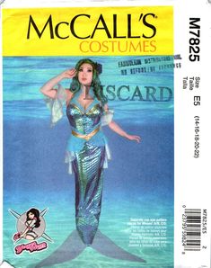 a woman in a mermaid costume standing under water