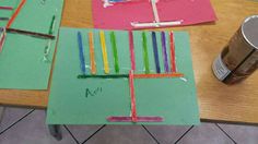 the craft is made with construction paper and colored sticks on top of each piece of cardboard