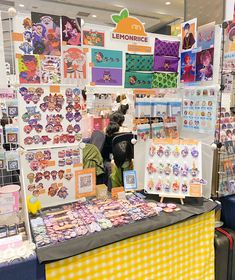 a table with lots of magnets and pictures on it in a store display area