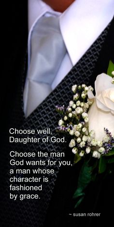 a close up of a person wearing a suit and tie with a white rose on it