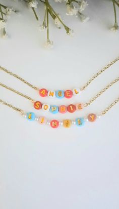 Simply adorable, colorful and oh, so sweet! This cute and fun necklace can be personalized with any name or word that you would like for your personalized necklace. Letters are randomly chosen from the color palette shown in the photos for a unique personalized style. The beads are made from a plastic resin material with an inlay of a gold printed letter. The Chain is a 12K gold plated hand cut chain. We hand cut each chain for all our guests. We ensure that each necklace is carefully crafted with all the personal details for your special order.  N E C K L A C E   L E N G T H S Lengths available: 12 Inches, 13 Inches, 14 Inches, 15 Inches, 16 Inches, 18 Inches and 20 Inches. If you need a length that is not offered in the dropdown menu, please reach out to us and we will be more than happy Bead Name Necklace, Toddler Necklace, Artisan Gift, Bright Colored, Childrens Jewelry, Letter Beads, Gold Print, White Gift Boxes, Plastic Resin