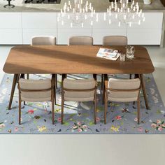 a dining room table with chairs and a chandelier