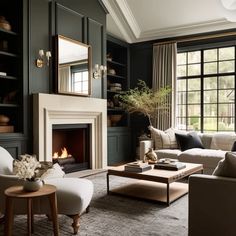 a living room filled with furniture and a fire place in front of a large window