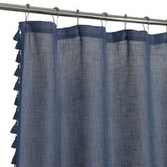 a blue curtain with fringes hanging from it's rod, against a white background