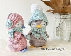 two small crocheted penguins sitting next to each other