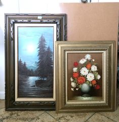 two framed pictures with flowers in them on the floor next to each other and a painting of a lake