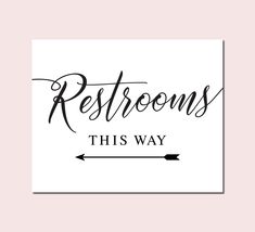 the words restrooms, this way are in black and white on a pink background