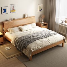 a large bed sitting next to a window in a bedroom on top of a hard wood floor