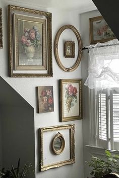 there are many framed pictures on the wall in this room, including flowers and frames