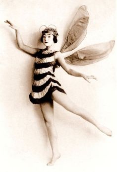 an old photo of a woman dressed as a bee