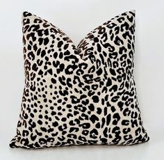 a leopard print pillow on a white background