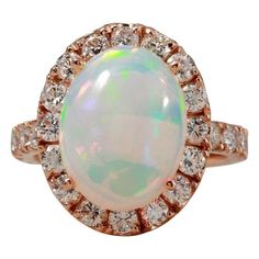 6.70 Carats Natural  Impressive Ethiopian Opal and Diamond 14K Solid Rose Gold Ring Suggested Replacement Value: $6,800.00 Total Natural Opal Weight is: Approx. 5.00 Carats  Total Natural Round Diamonds Weight: Approx. 1.70 Carats (color G-H / Clarity SI1-SI2) Ring total weight: 6.0 grams Disclaimer: all weights, measurements and colors are approximate and may vary slightly from the listed dimensions or as seen in the image. All pictures are magnified to show the smallest of details. Please, ref Luxury Rose Gold Opal Ring, Luxury Rose Gold Opal Gemstone Ring, Formal Rose Gold Opal Ring With Diamond, Formal Rose Gold Opal Ring, Ring Rosegold, Natural Opal, Opal Jewelry, Opal Rings, Cocktail Rings