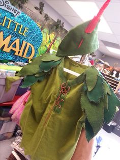 the back of a child's green shirt with leaves on it