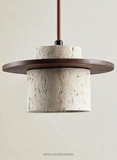 a white and brown light hanging from a ceiling fixture