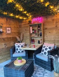 an outdoor seating area with wicker furniture and potted plants on the side wall