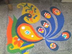 a colorful painting on the ground in front of a door