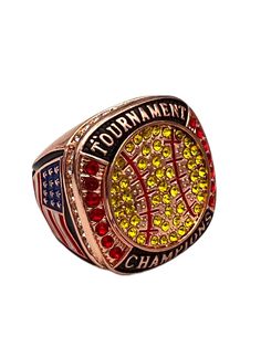 a gold and red ring with the word tournament written on it's center, surrounded by american flags