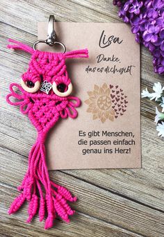 a pink crocheted keychain with an owl on it