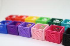 colorful plastic baskets lined up on a white surface