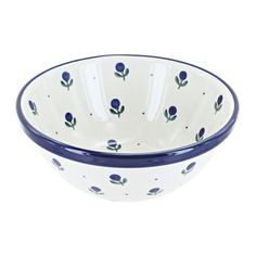 a blue and white bowl with flowers on the rim, sitting in front of a white background