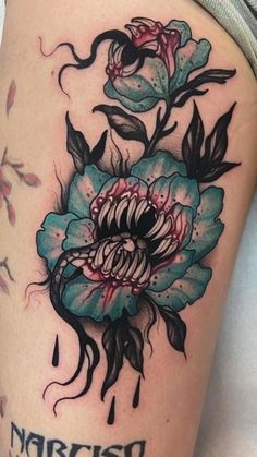 a woman's thigh with flowers on it and the words narciss written in black ink